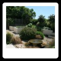 Water feature and vegetable garden in back ground